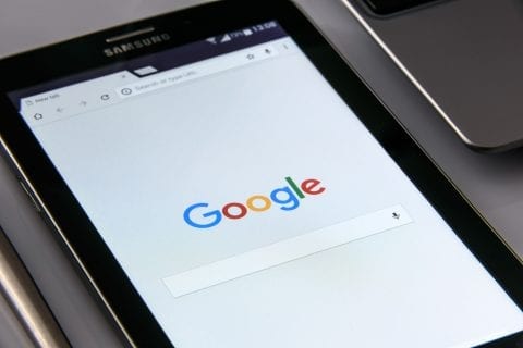 Mobile phone with Google search page open for the user to look for answers from companies getting found on Google with Digital Marketing